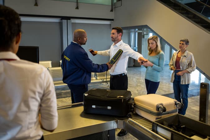 Security Guard Frisk Passengers Standing Queue